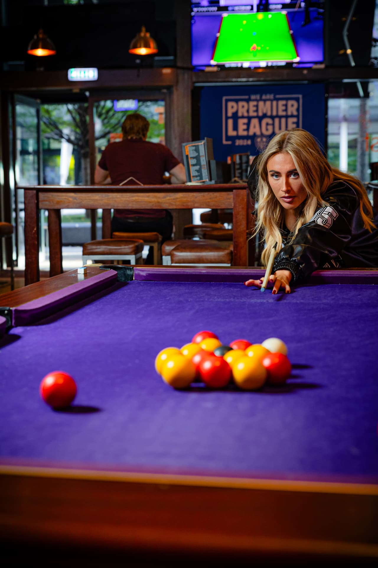 Lining up a shot on the pool table at Toast